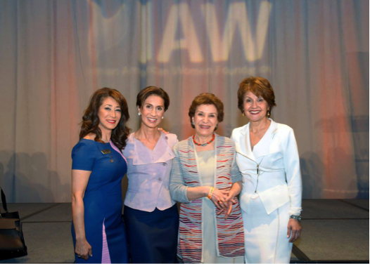 Leaders and activists pose at IAWF event. 