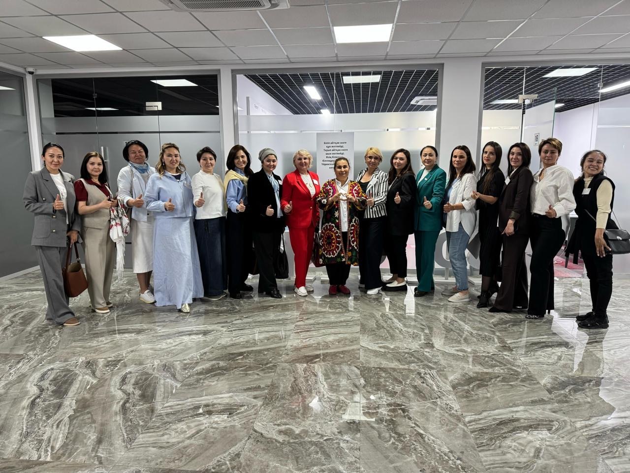 17 climate justice training participants in Kazakhstan standing in a line smiling at the camera
